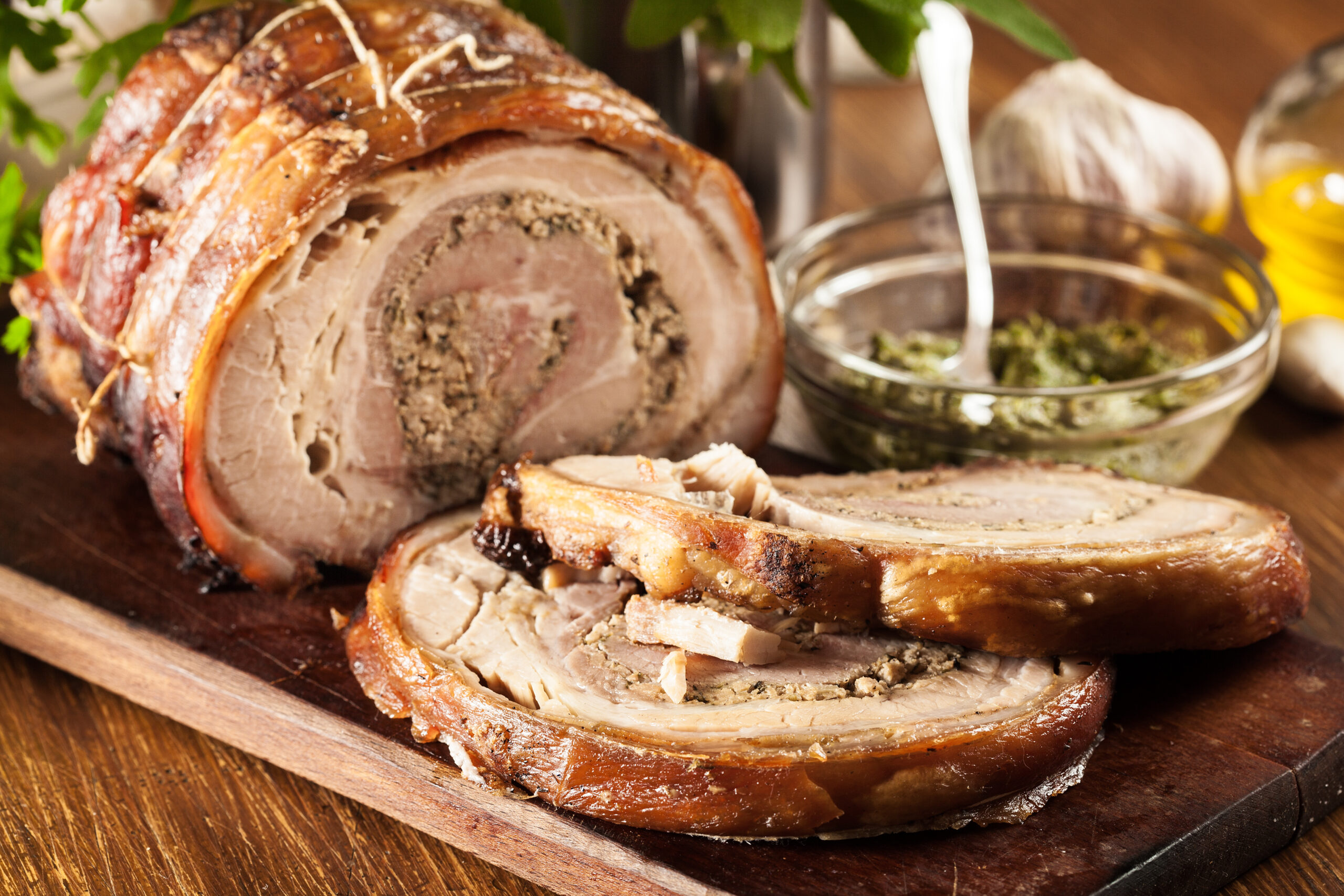 Traditional italian porchetta. Rolled pork belly stuffed with mincemeat and herbs.