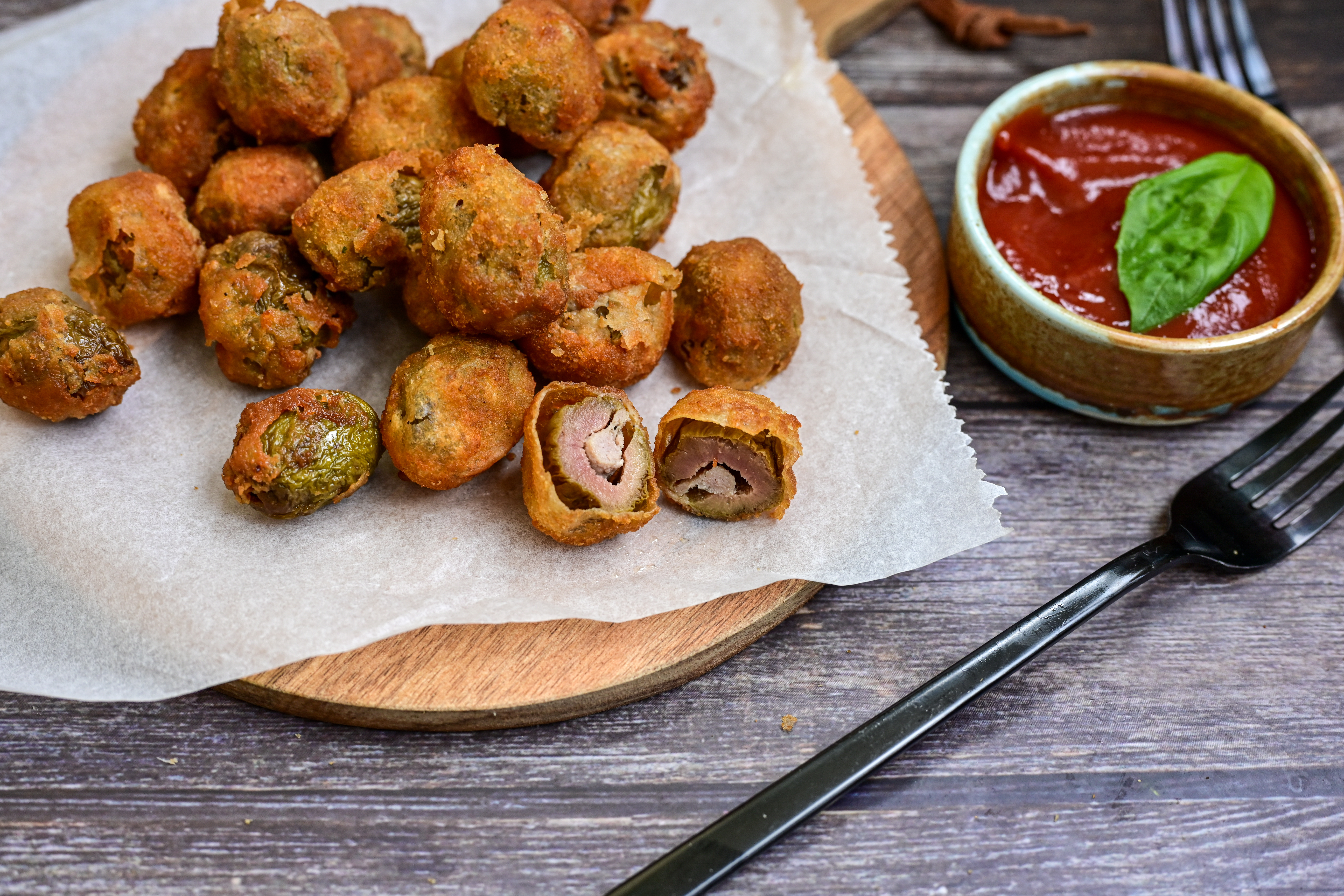 Olive all'ascolana..The typical Italian street-food appetizer with breaded fried olives stuffed of meat.
